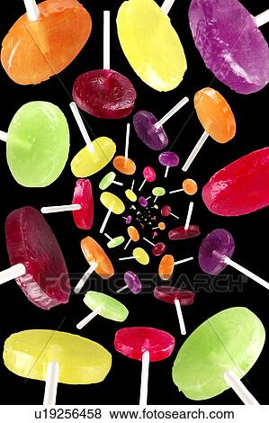 Flying lollypops on black View Large Photo Image Stock Photo - Flying lollypops on black. Fotosearch