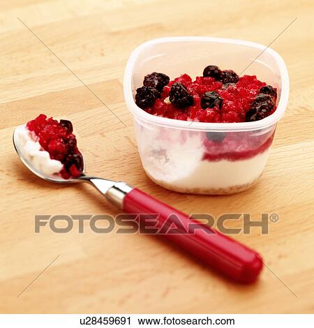 Stock Image - Frozen yoghurt and summer fruits dessert. Fotosearch