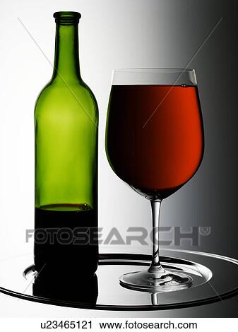 Stock Image - Glass of Red Wine With Bottle - Non Exclusive. Fotosearch