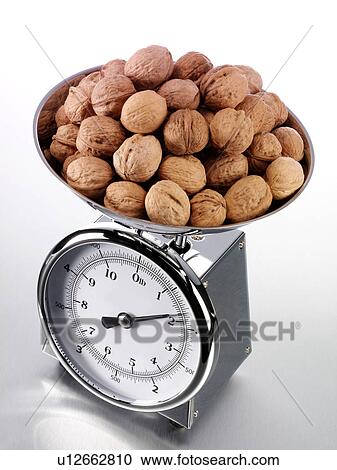 Stock Image - Kitchen Scales With Walnuts - Non Exclusive. Fotosearch