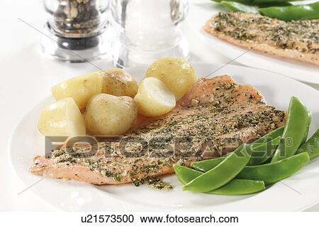 Stock Image - Trout with potatoes and snow peas. Fotosearch