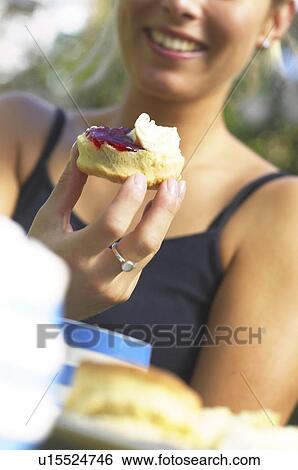 Stock Photograph - Scone with Jam and Cream. Fotosearch