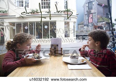 Stock Image - Children Eating in Cafe. Fotosearch