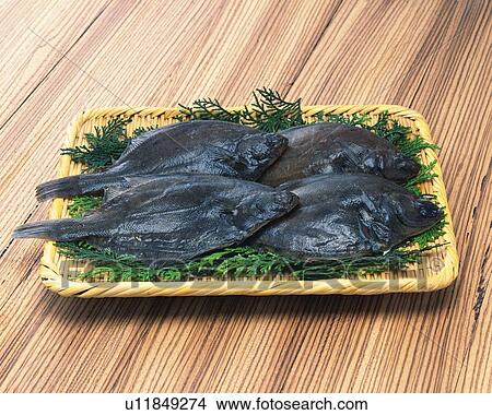 Picture - Flounders on bamboo basket, high angle view. Fotosearch