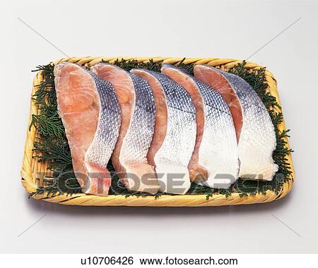 Stock Photograph - Salmon fillets on bamboo basket, high angle view. Fotosearch