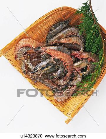 Stock Image - Shrimps on bamboo basket, high angle view. Fotosearch