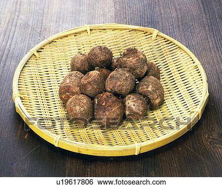 Stock Photograph - Taros on bamboo basket, high angle view. Fotosearch