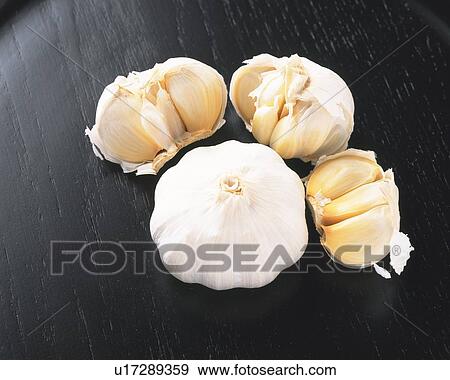 Whole garlic and cloves, high angle view View Large Photo Image Stock Photo - Whole garlic and cloves, high angle view. Fotosearch