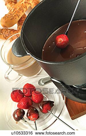Stock Photograph - Chocolate fondue with strawberries. Fotosearch