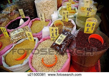 Stock Image - A variety of beans and grains in large bags, on display in a store. Fotosearch