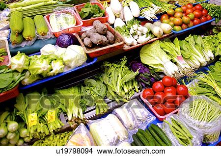 A variety of fresh vegetables on trays, on display in a market stall View Large Photo Image Picture - A variety of fresh vegetables on trays, on display in a market stall. Fotosearch