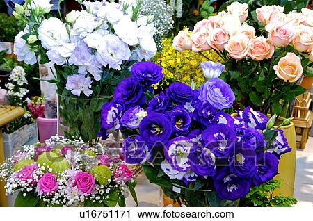 Stock Image - Bouquets of flowers in vases in a store. Fotosearch