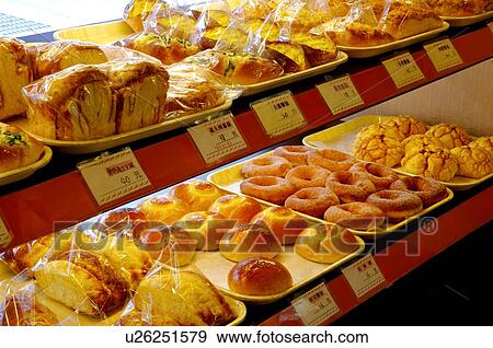 Stock Photo - Different types of bread, and buns on display in a bakery. Fotosearch