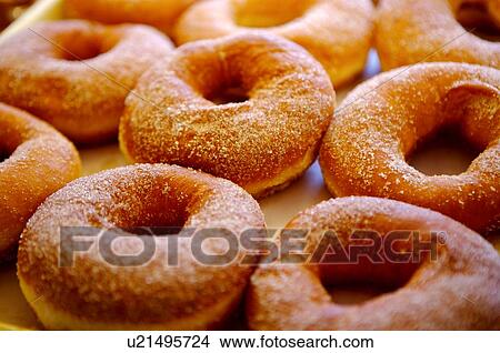 Picture - Donuts sprinkled with sugar on top, close-up. Fotosearch