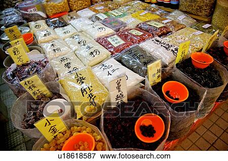 Stock Photo - Dried goods in packs, and in large plastic bags, on display at a store. Fotosearch