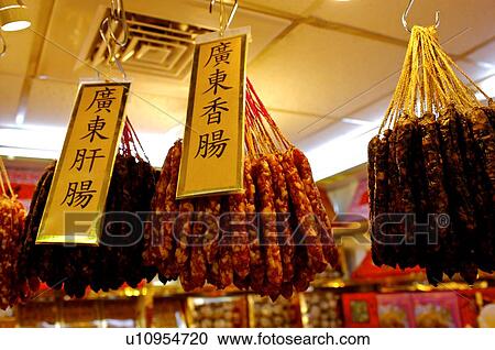 Dried preserved pork sausages hanging from hooks, on display with signs in a store View Large Photo Image Stock Image - Dried preserved pork sausages hanging from hooks, on display with signs in a store. Fotosearch