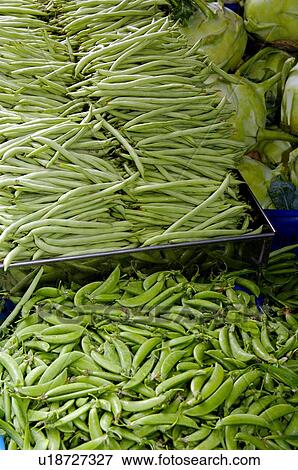 Stock Photo - Fresh green beans in piles, on display in a market stall. Fotosearch
