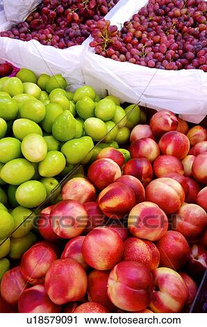 Fresh peaches, green dates, and grapes on display at a market stall View Large Photo Image Stock Image - Fresh peaches, green dates, and grapes on display at a market stall. Fotosearch