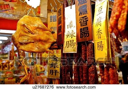 Preserved meat sausages and duck with signs, hanging from hooks, on display in front of a store View Large Photo Image Stock Photograph - Preserved meat sausages and duck with signs, hanging from hooks, on display in front of a store. Fotosearch