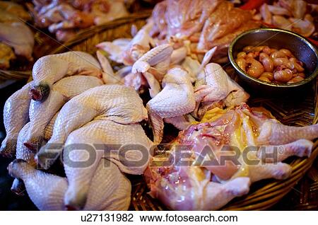 Raw chicken parts on display in a shallow straw basket, in a market stall View Large Photo Image Stock Image - Raw chicken parts on display in a shallow straw basket, in a market stall. Fotosearch