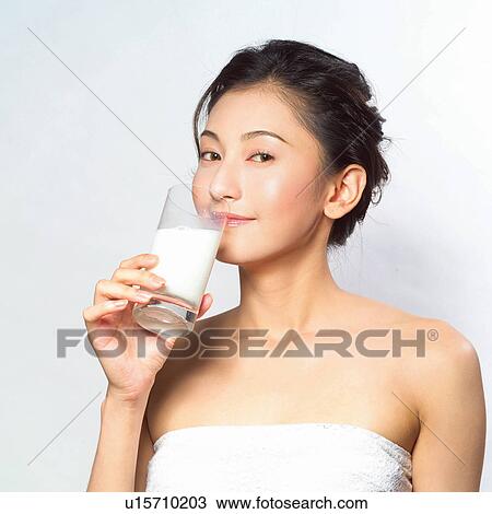 Stock Image - Asian woman drinking milk. Fotosearch