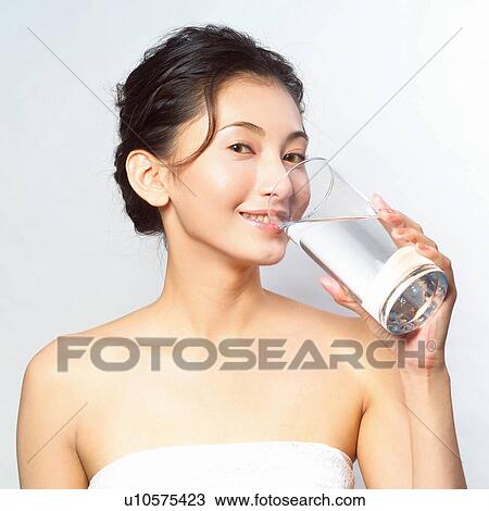 Stock Image - Asian woman drinking water . Fotosearch