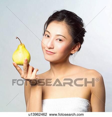 Asian woman eating a pear View Large Photo Image Stock Image - Asian woman eating a pear. Fotosearch