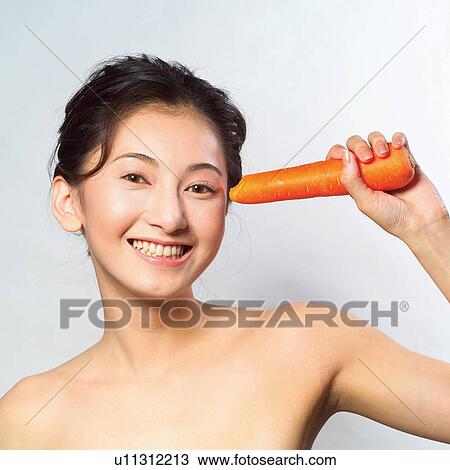 Stock Image - Black Hair, Close-Up, Cheerful, Carrot, Asian Ethnicity. Fotosearch