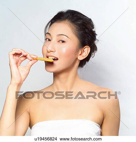 Picture - Hair Back, Biscuit, Indoor, Eating, One Person, Beauty. Fotosearch