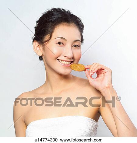 Stock Image - Looking At Camera, Asian Ethnicity, Holding, Square, Close-Up. Fotosearch