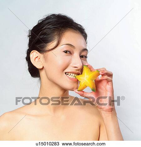 Stock Image - One Person, Hair Back, Star fruit, Black Hair, Food And Drink, Head And Shoulders, Star Shape. Fotosearch