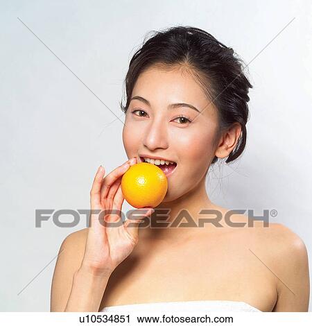 Stock Image - Young Adult, Beauty, Hair Back, Holding, Close-Up, Leisure Activity. Fotosearch