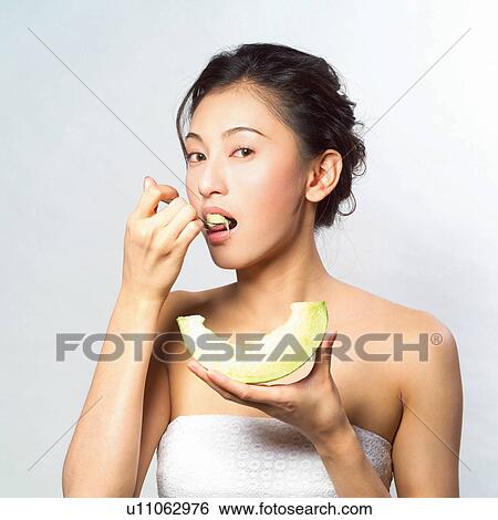 Stock Photograph - Youth Culture, Mouth Open, Indoor, Black Hair, Eating. Fotosearch