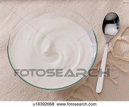 Stock Photo - crockery, milk product, glass, spoon, liquid, table cloth, bowl. Fotosearch