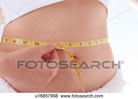 Stock Photo - measuring tape, human hand, holding, white background, one person, woman only. Fotosearch