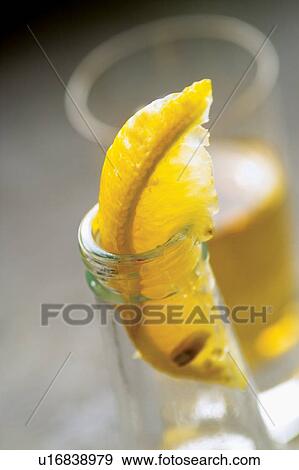 Stock Photo - Lemon, Glass, Slice, Half Full, Drink, Liquid. Fotosearch
