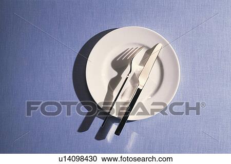 Stock Image - Folk and Knife on the Plate, High Angle View, Copy Space. Fotosearch