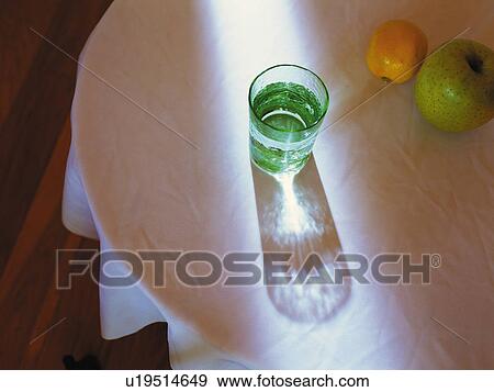 Glass that is Reflecting Sunlight and Fruit on the Table, High Angle View View Large Photo Image Stock Photo - Glass that is Reflecting Sunlight and Fruit on the Table, High Angle View. Fotosearch