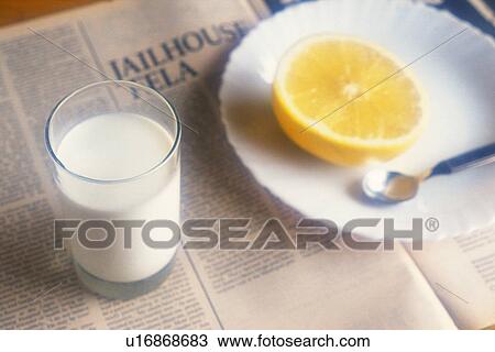 Stock Image - Milk and Grapefruit and Newspaper, High Angle View, Soft Focus. Fotosearch