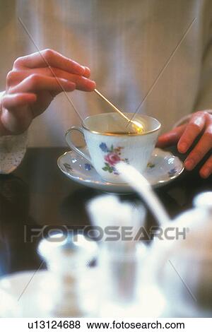 Stock Photo - Woman Stiring a Coffee, Front View, Soft Focus. Fotosearch