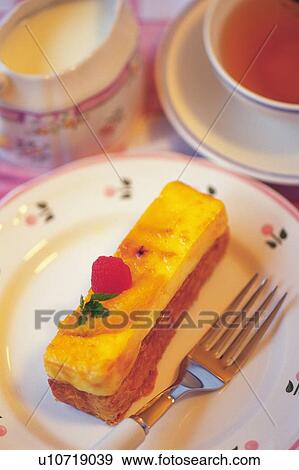 Stock Photo - Cake on the Plate Served with Tea, High Angle View. Fotosearch