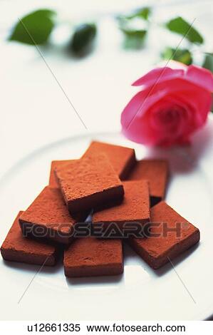Stock Photography - Chocolate on the Plate and a Rose, High Angle View. Fotosearch