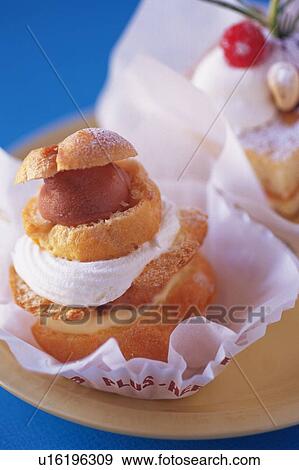 Stock Photo - Cream Puff and Cake on the Plate, High Angle View. Fotosearch