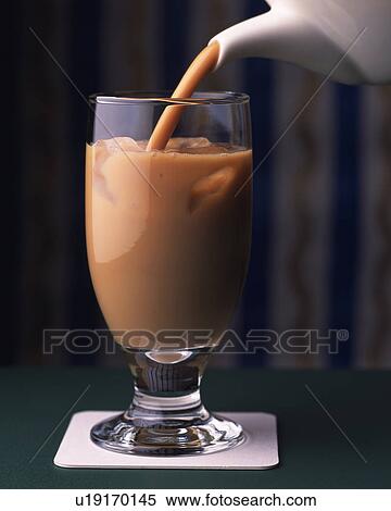Stock Photography - Cafe au Lait that is Poured in the Glass, Full Frame, Differential Focus, Front View. Fotosearch