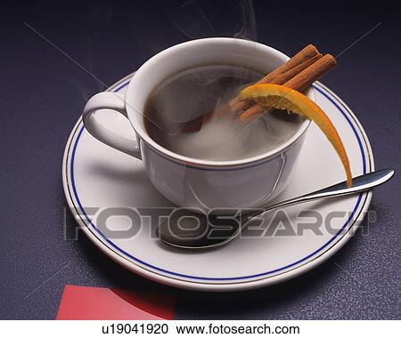 Stock Image - Coffee with Cinnamon Stick and Orange, High Angle View, Full Frame. Fotosearch