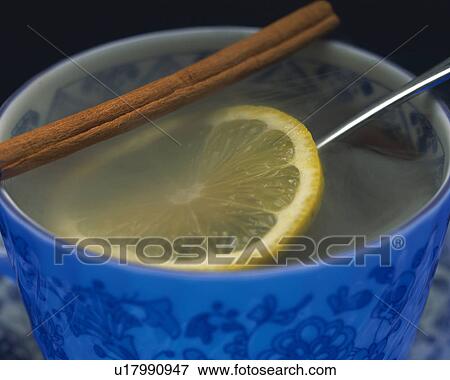 Stock Photo - Drink that is Putting Cinnamon and Lemon, Close Up, Full Frame. Fotosearch