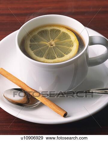 Drink with a Lemon Slice and Cinnamon Stick, High Angle View, Full Frame View Large Photo Image Stock Photo - Drink with a Lemon Slice and Cinnamon Stick, High Angle View, Full Frame. Fotosearch