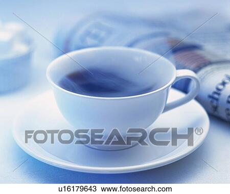 Stock Image - Hot Coffee and Newspaper, Full Frame, Differential Focus. Fotosearch
