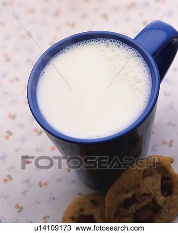 Stock Image - Hot Milk and Cookie, High Angle View, Full Frame, Differential Focus. Fotosearch
