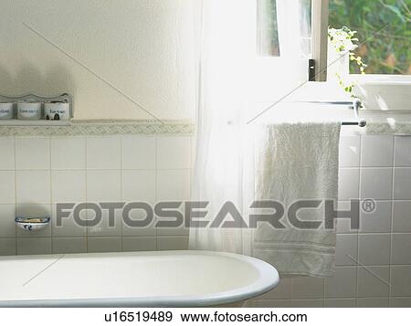 Stock Photo -  a Bathroom With a White Bathtub and a Towel, High Angle View. Fotosearch